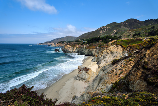Big Sur is a rugged and mountainous section of the Central Coast of the U.S. state of California, between Carmel Highlands and San Simeon, where the Santa Lucia Mountains rise abruptly from the Pacific Ocean. It is frequently praised for its dramatic scenery.