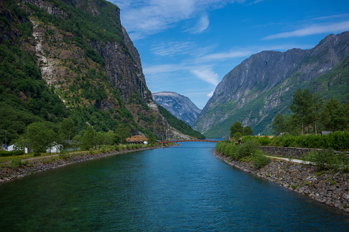 The Naeroydalselvi River near the village of Aurland, Norway flows through a valley in the summer months.