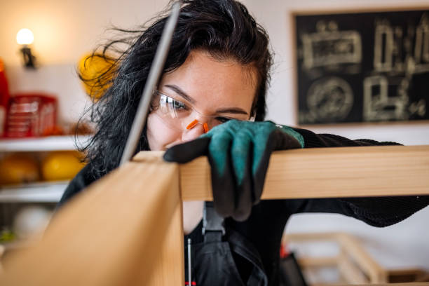 istock Woman starting small business working as carpenter using file 1949218210