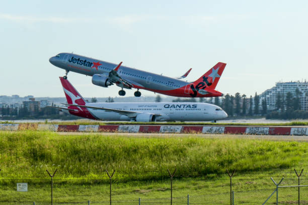 jetstar a321 pasando qantas b787 - boeing 787 fence airport security fotografías e imágenes de stock