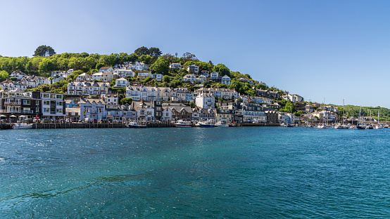 Looe, Cornwall, England, UK - May 27, 2022: View of the boats and houses on the East Looe River