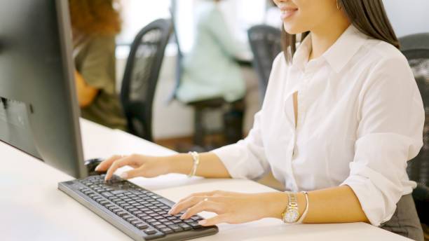 istock Hands of an asian woman using computer in a coworking 1949238268