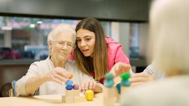 istock Nurse advising an old woman to resolve a skill game 1949241867