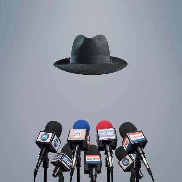 Microphones prepared for the press conference and invisible anonymous speaker: fake news, disinformation and propaganda concept