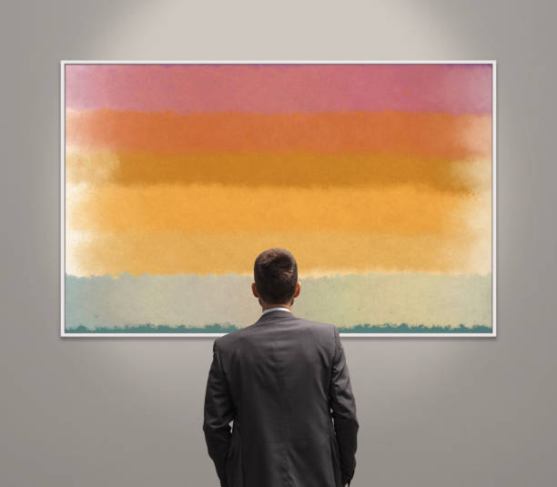 Man in the art gallery looking at paintings, abstract contemporary art concept