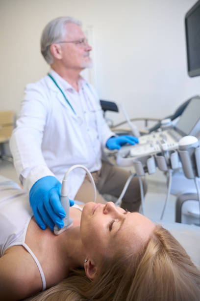 istock Female getting thyroid ultrasound exam in hospital 1949271027