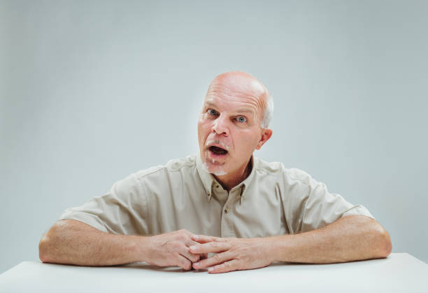 istock Bewildered elder hears news, shows utter astonishment 1949276282