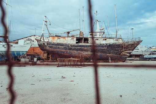 An abandoned cape islander fishing boat near a small fishing village.