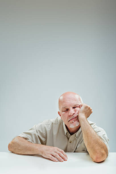 istock Overwhelmed elder rests head, symbolizing sheer frustration 1949289126