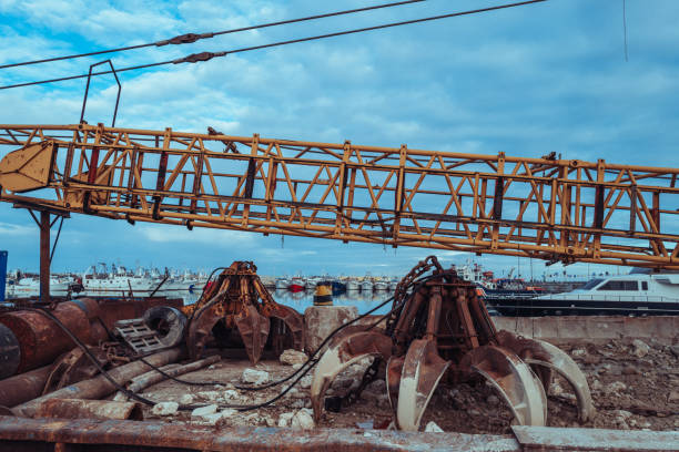 Wreck and rusty mining excavator in old abandoned tin mine in Takua Pa, Phang Nga, Thailand.