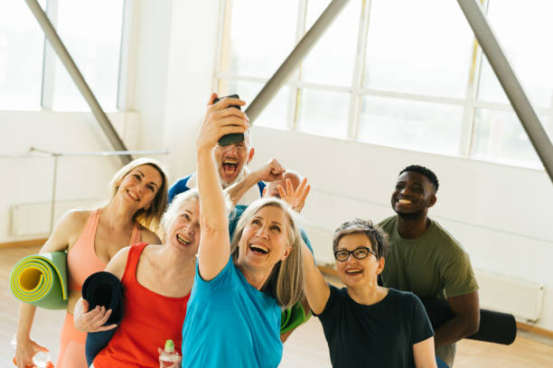 istock Pensioners athletes taking selfies on smartphone in gym 1949327497
