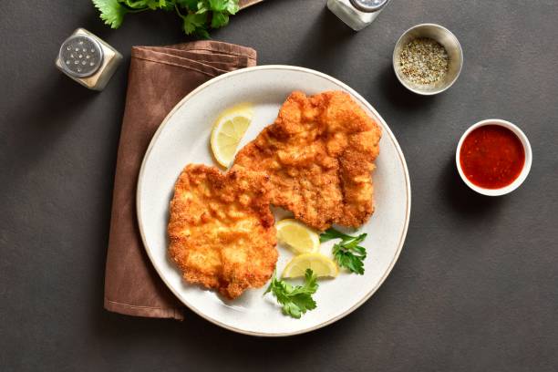 istock Schnitzel with lemon and leaves of parsley 1949333458