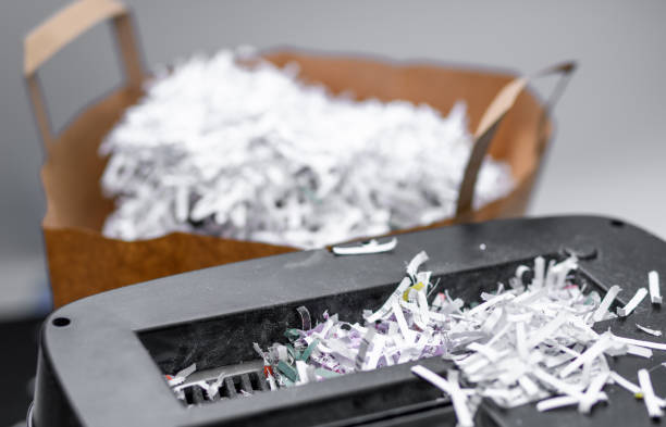 Paper shreds from the shredder, destroyed company documents in the office