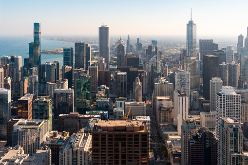 Chicago skyline with office buildings, business cityscape architecture and lake Michigan with blue sky. Aerial drone footage. Illinois, USA, North America