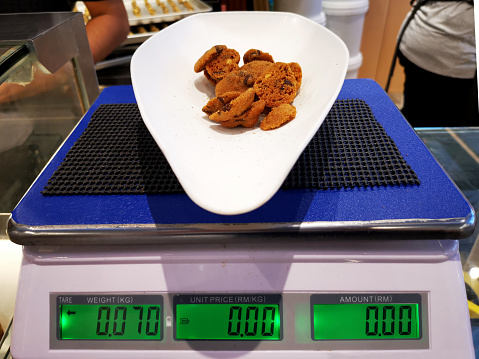 Focus scene on weighing scale in cookie shop