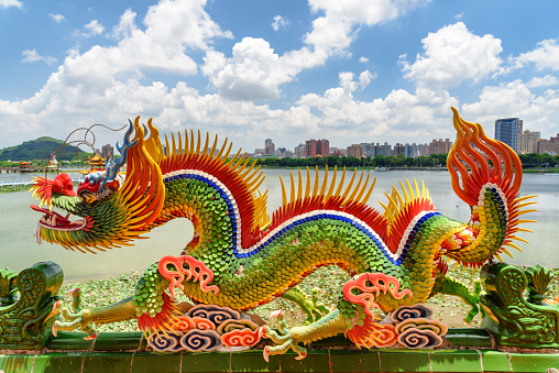 Kaohsiung, Taiwan - April 30, 2019: Colorful detail of the Dragon and Tiger Pagodas at Lotus Lake. Awesome dragon sculpture. The temple is a popular tourist attraction of Asia.