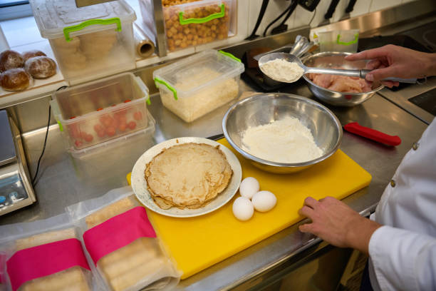 istock Chef prepares pancakes in a professional kitchen 1949375732