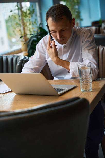 istock Cook communicates with contractors on his mobile phone 1949376246
