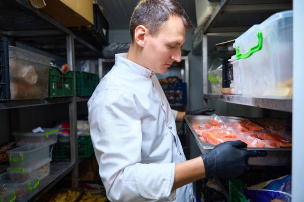 istock Kitchen employee with a tray in a restaurant refrigerator 1949376256