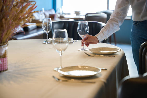 istock Waitress places a large glass by the plate 1949376781