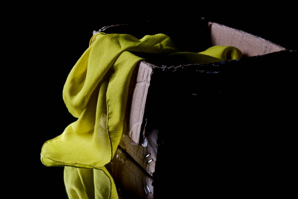 istock cloth dangling from a cardboard box, a cardboard box filled with cloth 1949381001
