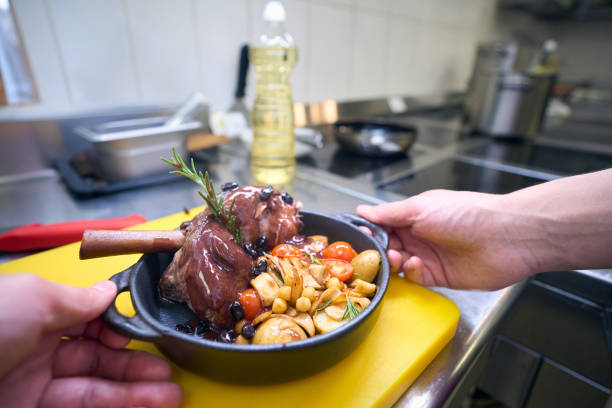 Cook prepared the meat with vegetables and sauce, he uses quality products