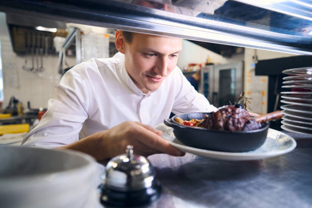 istock Young man has prepared lamb shank with vegetables for serving 1949383077