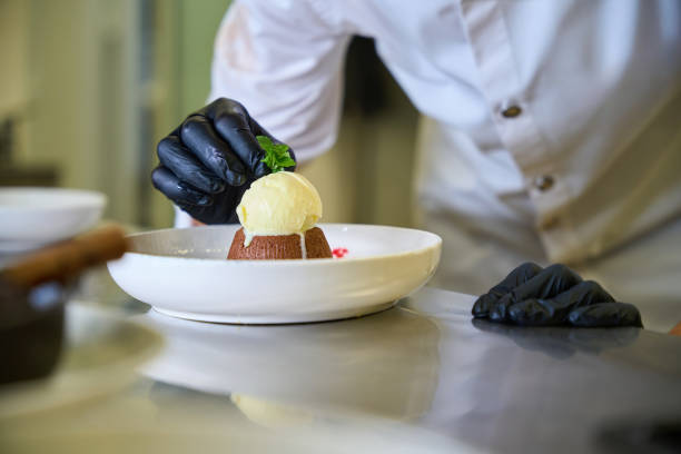 istock Pastry chef prepares a chocolate dessert for serving 1949387767