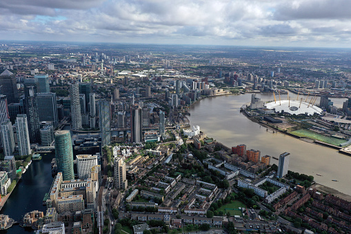 London Cityscape with the Canary Wharf business diestrict and the river thames. The high angle image was captured during summer season.