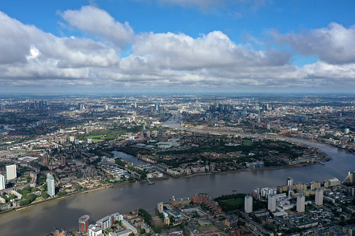 London Cityscape with the Canary Wharf business diestrict and the river thames. The high angle image was captured during summer season.