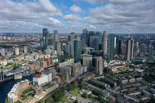 London Cityscape with the Canary Wharf business district and the river thames. The high angle image was captured during summer season.