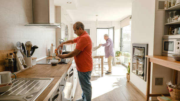 istock Gay couple working at kitchen and cleaning table 1949410660