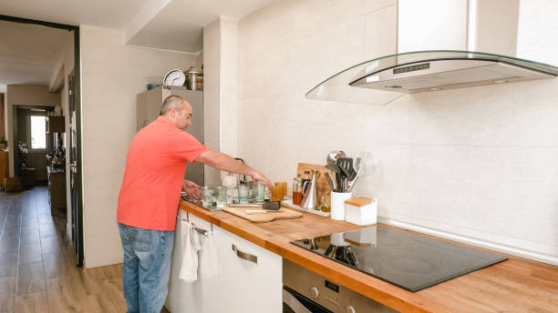 istock Unrecognizable man cleaning the dishes at kitchen 1949412732