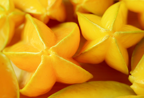 Closeup of Pile of Fresh Ripe Vibrant Yellow Star Fruits or Carambola