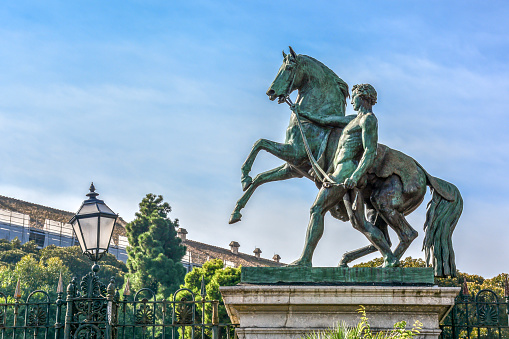 Naples, Italy 10-01-2016 The The bronze Statue of man and horse in front of the garden of Royal Palace in Naples, Campania, Italy.