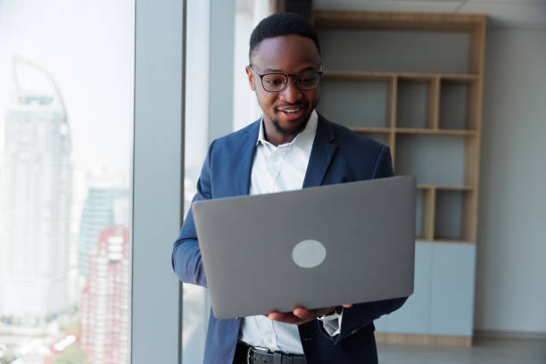 istock Black people Businessman using mobile laptop in the room 1949434796