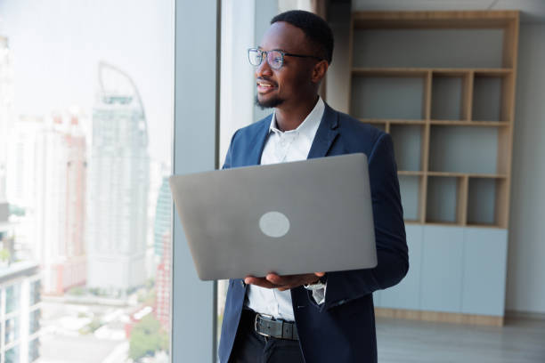 istock Black people Businessman using mobile laptop in the room 1949435308