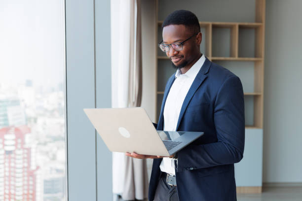 istock Black people Businessman using mobile laptop in the room 1949435329
