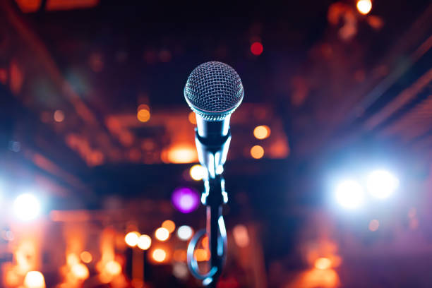 istock Microphone on stage against a background of auditorium. 1949458858