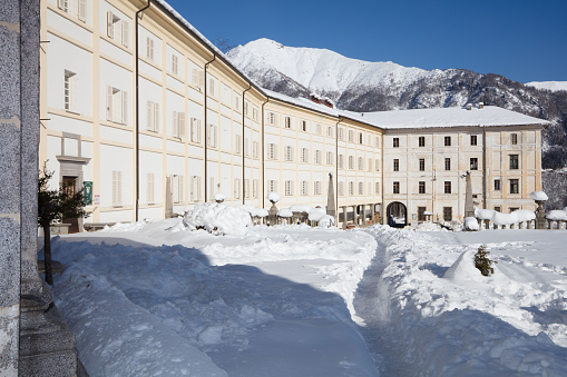 The Sanctuary of San Giovanni d'Andorno is covered by fresh snow and lit by the winter sun.