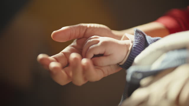 SLO MO Dolly Shot of Baby Boy's Hand on Mother's Palm at Bright Home