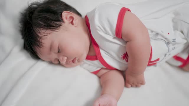 Close-up shot of sweet newborn baby lying in bed. that takes care of happy families and children childhood parenthood
