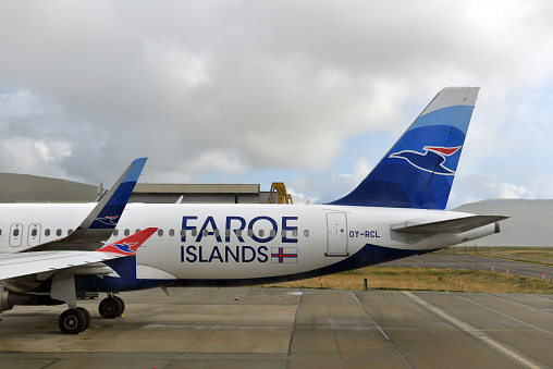 Atlantic Airways airplane on   the ground on a dramatic cloudy day on Faroe Islands