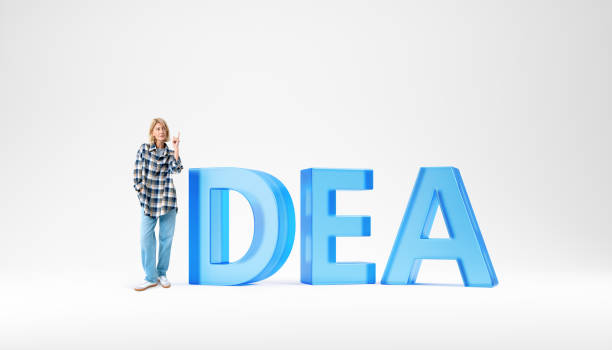Portrait of young European woman standing near big idea sign over white background. Concept of planning and brainstorming