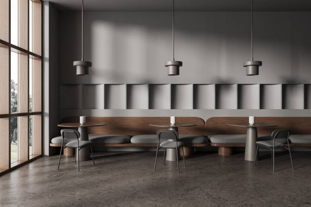 istock Grey cafe interior with chairs and table in row, dining space with window 1949488427