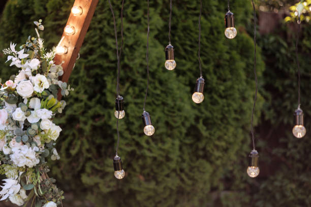 istock Light bulbs on a floral wedding arch 1949495887