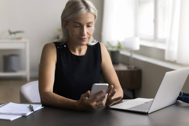 istock Attractive woman use smartphone during break at work 1949502848