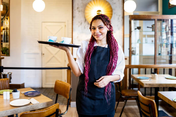 Waitress serving sweet pizza to customers in a pizzeria