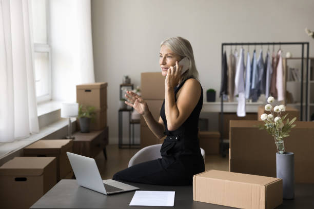 istock Designer working from storehouse, speaks to partner by phonecall 1949513454
