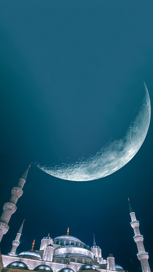 Sultanahmet or Blue Mosque with crescent moon. Ramadan or laylat al-qadr or kadir gecesi or islamic concept background photo.